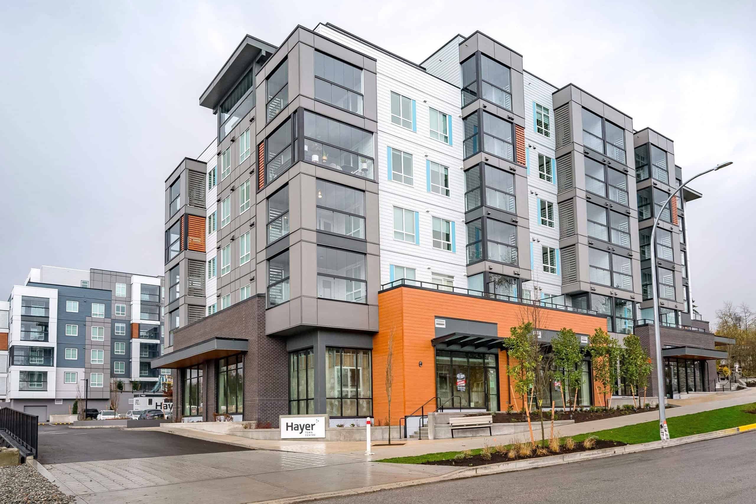 Contemporary multi-family residential building in Vancouver featuring modern architecture, large windows, and mixed-use commercial space on the ground floor. Perfect for Vancouver property investment and real estate opportunities.