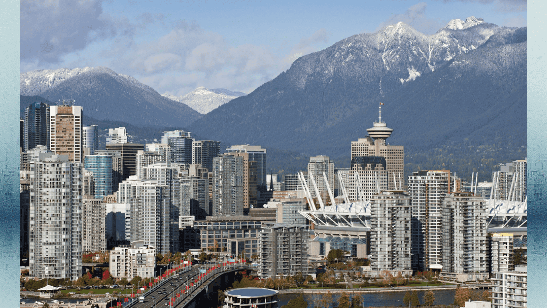 An image showcasing Vancouver's cityscape with high-rise buildings and the surrounding snow-capped mountains, highlighting the region's urban development and natural beauty.