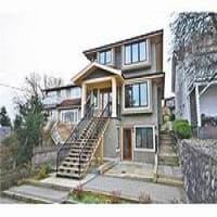 Modern multi-story residential property with large windows, landscaped front yard, and staircase entrance in a suburban neighbourhood, showcasing Orca Realty Inc. services in real estate.