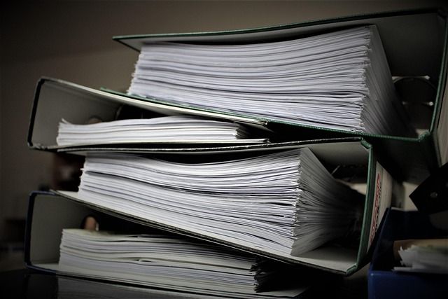 Stacked binders filled with paperwork
