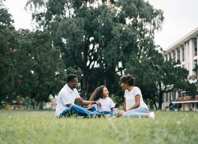 family sitting in grass