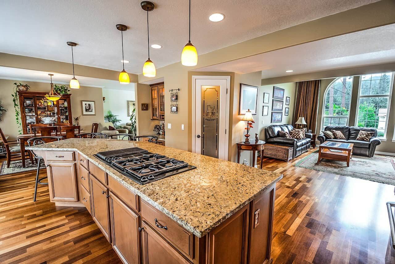 Bright open-concept kitchen and living room with large windows, hardwood flooring, and modern furnishings, perfect for family living and entertaining in a spacious Vancouver home.