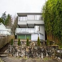 Orca Realty Inc. modern multi-story residential building with balconies and landscaped yard in Vancouver, BC, showcasing contemporary urban living.