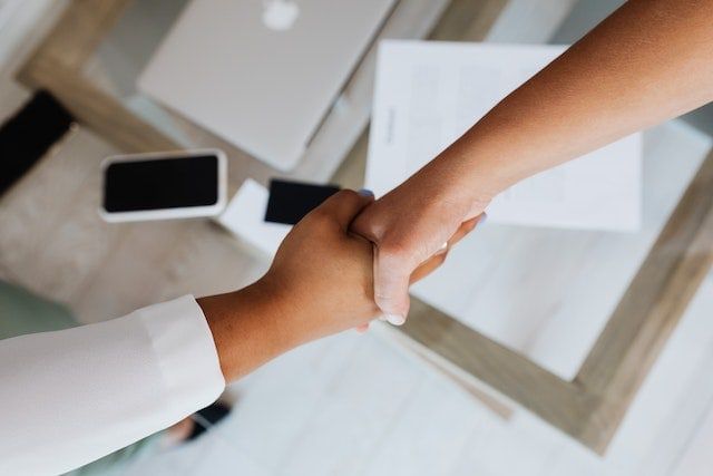 shaking hands across table