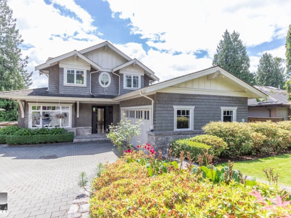 Stunning contemporary house with lush landscaping and spacious driveway, featured by Orca Realty Inc., showcasing prime real estate in the Vancouver area.