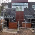 Contemporary townhouse with modern architecture, large windows, and a privacy-enhancing exterior design, available through Orca Realty Inc. in Vancouver's real estate market.