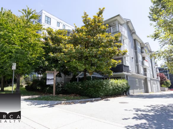 Spacious modern residential apartment building with balconies and lush greenery, located in a vibrant Vancouver neighbourhood, ideal for real estate investment or rental opportunities in BC.