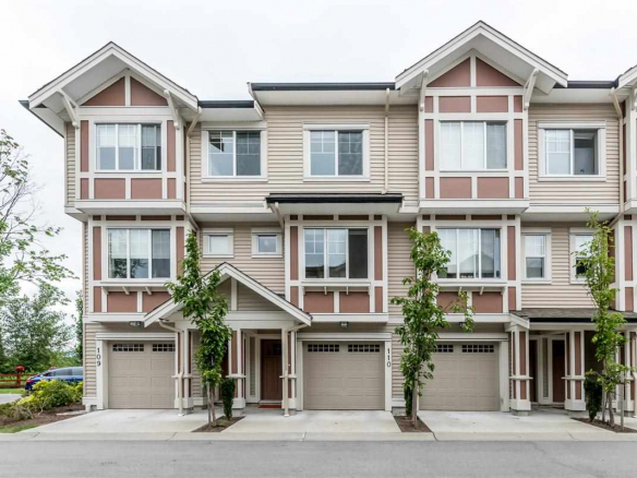 Contemporary multi-family residential building with attached garages, modern design, and landscaped surroundings – ideal for Vancouver Island real estate investments and property management.