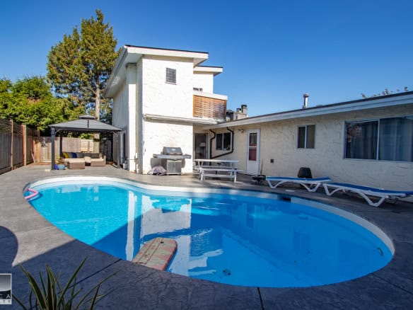 Swimming pool backyard view at Orca Realty Inc. - Vancouver Island real estate agents, showcasing beautiful outdoor spaces and swimming pools for potential homebuyers.