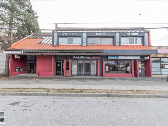 Poirier Dance Studio building in downtown area, featuring a vibrant red exterior, large glass windows, and signage for dance, fitness, and arts studios, ideal for commercial real estate in Victoria.