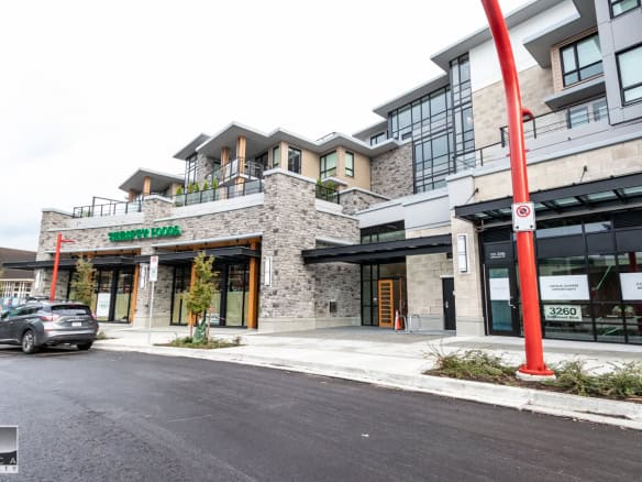 Modern mixed-use commercial and residential building in Vancouver with retail storefronts and upper-level condos by Orca Realty Inc.