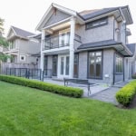Luxury modern two-storey family home with landscaped backyard, large backyard deck, and garden, perfect for outdoor living and entertaining.