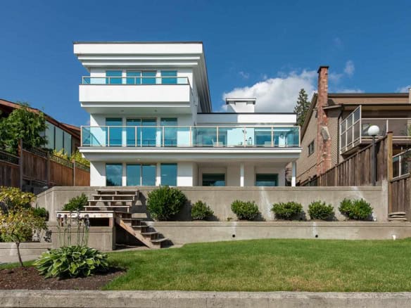 Modern waterfront luxury home with expansive ocean views and stylish outdoor living space in Vancouver. Perfect for upscale real estate buyers seeking contemporary design and prime location.