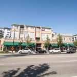 Modern multi-story convenience store retail building with commercial spaces and apartments, Vancouver BC. Prime location for real estate investment, retail, and rental income opportunities.