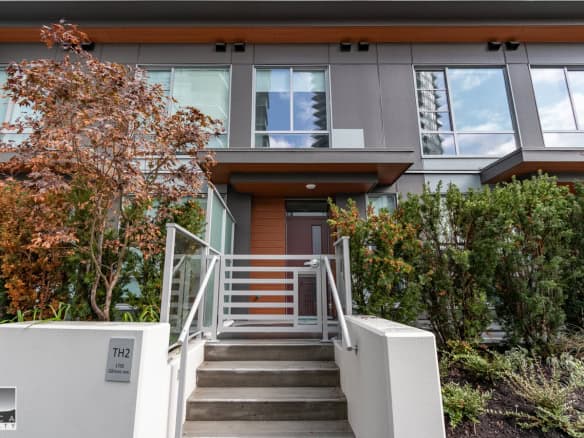 Modern townhouse front entrance in Vancouver, BC with landscaped garden and contemporary design, ideal for real estate investment or homeownership in the OCARA Realty portfolio.