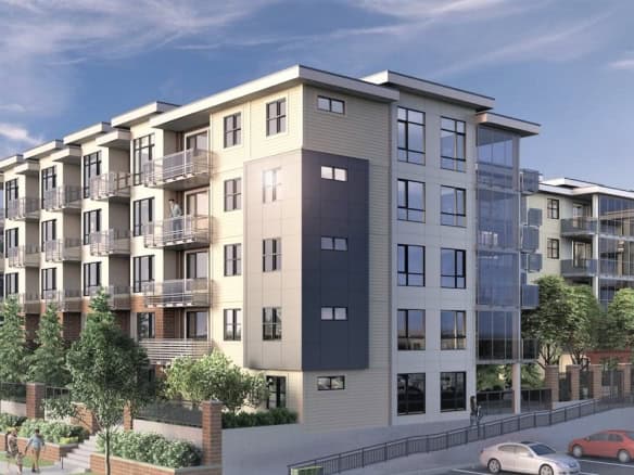 Modern multi-story residential building with contemporary architecture, large windows, balconies, and lush landscaping, representing Orca Realty Inc.'s property listings and real estate services in Canada.