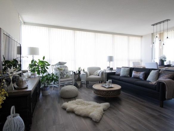 Bright and modern living room in Vancouver real estate, featuring a spacious layout, stylish furniture, large windows with natural light, and elegant decor, ideal for condo buyers.