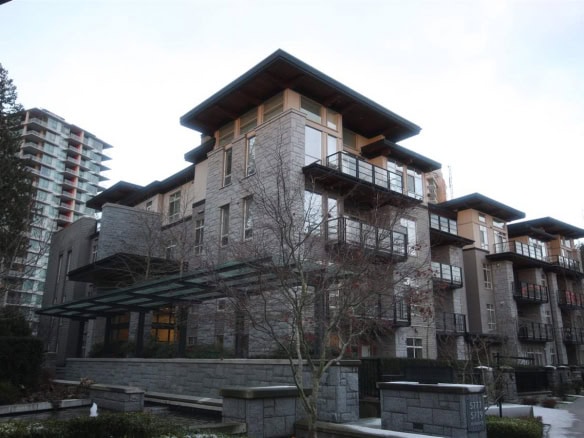 Contemporary residential building with modern architecture, stone accents, and spacious balconies in a Vancouver-area neighbourhood, ideal for real estate investment or luxury living.