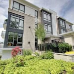 Modern multi-story residential building with large windows and landscaped garden in Vancouver, BC. Prime real estate property for sale or rent by Orca Realty Inc.