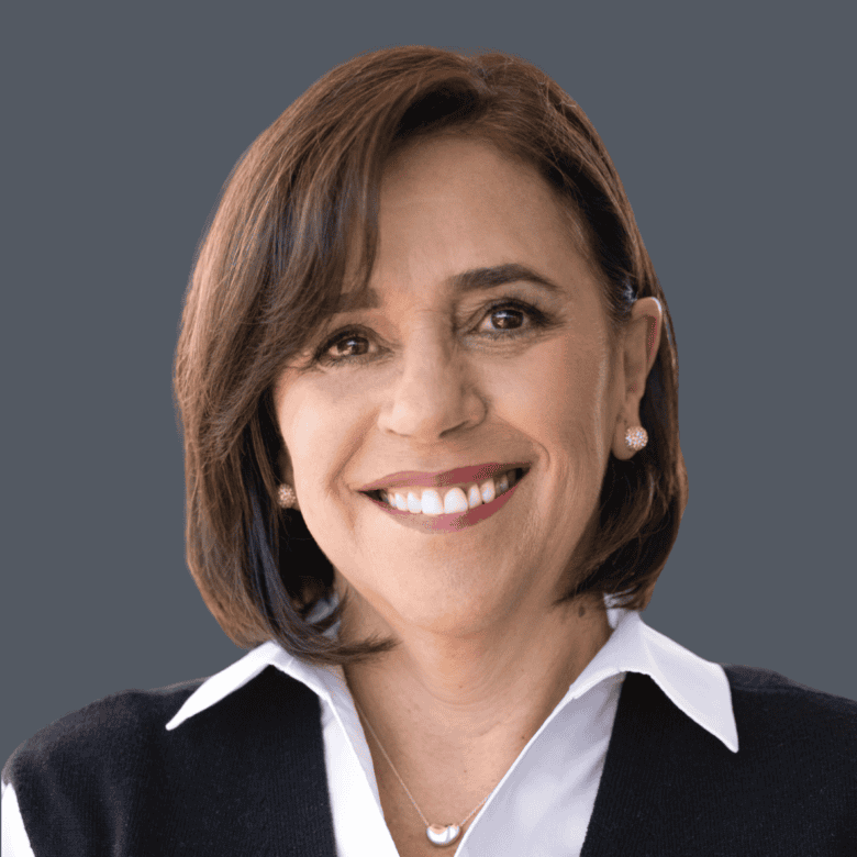 Friendly real estate agent portrait, smiling woman with brown hair, wearing professional attire, representing Orca Realty Inc., trusted Vancouver Island real estate expert.