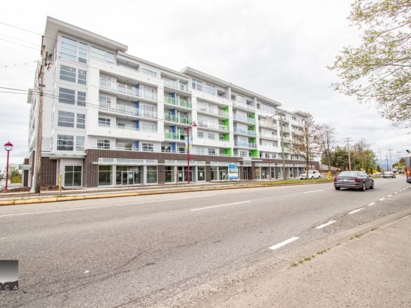 Modern multi-family residential apartment building in Vancouver, BC, showcasing contemporary design, balconies, and mixed-use commercial spaces, offered by Orca Realty Inc., your trusted Vancouver real estate experts.