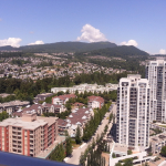 View of high-rise condos and residential neighbourhoods with mountains in the background, showcasing Vancouver real estate opportunities with Orca Realty Inc.