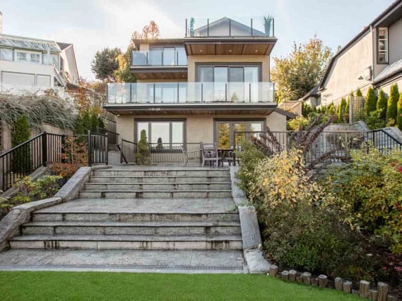 Luxurious modern residential home with expansive balconies, outdoor seating, and landscaped garden in Vancouver, BC, showcasing prime real estate listings by Orca Realty Inc.