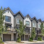 Modern townhouse row with contemporary exterior design, including balconies and large windows, located in a scenic residential neighbourhood in British Columbia.