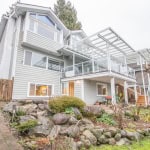 Modern multi-level house with spacious outdoor deck and landscaped garden in Vancouver, BC. Perfect for families and outdoor living enthusiasts seeking real estate in West Vancouver.