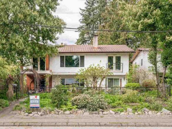 Charming two-storey home with lush front garden, perfect for family living, located in a quiet neighbourhood in Ontario.