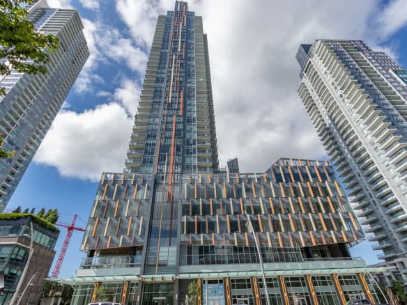 Modern high-rise condominiums in downtown Vancouver showcasing contemporary glass architecture and urban living. Prime real estate for buyers seeking luxury Vancouver condos.