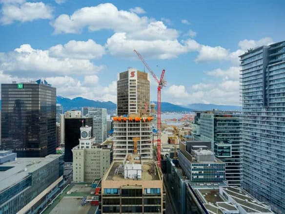 Modern Vancouver skyline with high-rise buildings and ongoing construction, showcasing urban development and real estate growth in the city.
