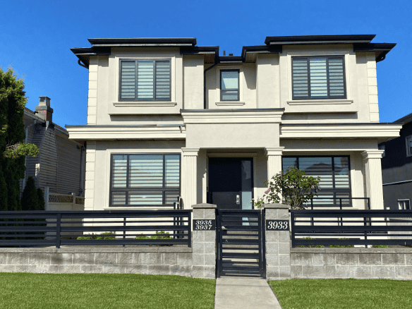Modern luxury home with contemporary architectural design, featuring large windows, a manicured lawn, and a stylish front gate, ideal for Vancouver property buyers.