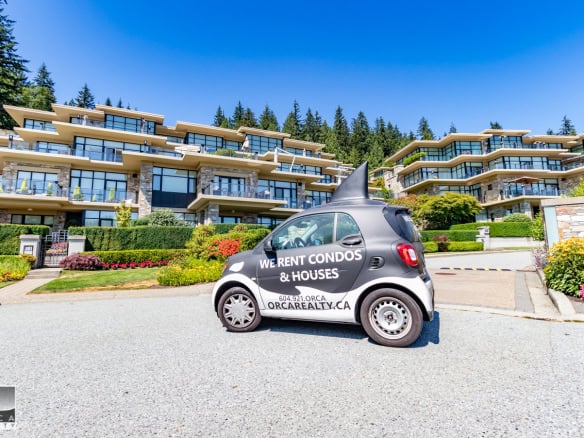 Luxurious multi-level condo building with modern architectural design in a scenic, wooded area in Vancouver, BC. Perfect waterfront properties, prime real estate, and condo rentals by Orca Realty Inc.