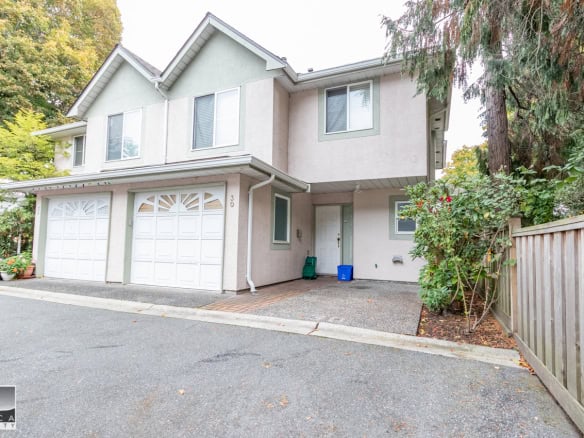 Modern duplex home with double garage and lush landscaping, perfect for families or investors, located in a desirable neighbourhood with easy access to amenities.