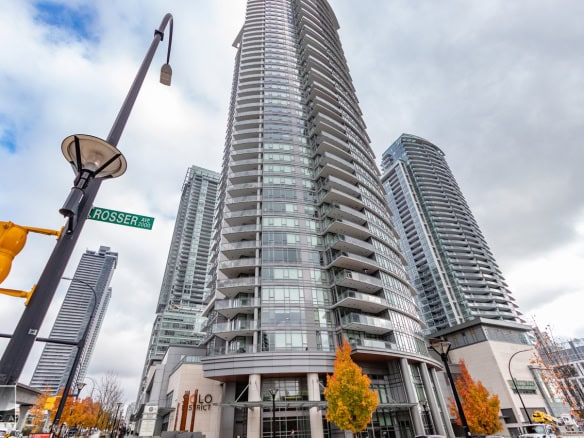 Modern high-rise condominium buildings in downtown Vancouver, BC, showcasing luxury residential apartments with panoramic city views and contemporary architecture.