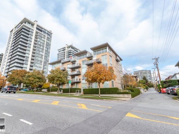 Contemporary residential building with mixed-use apartments and commercial space in a vibrant urban neighbourhood in Victoria BC. Modern architecture, balconies, and urban amenities.