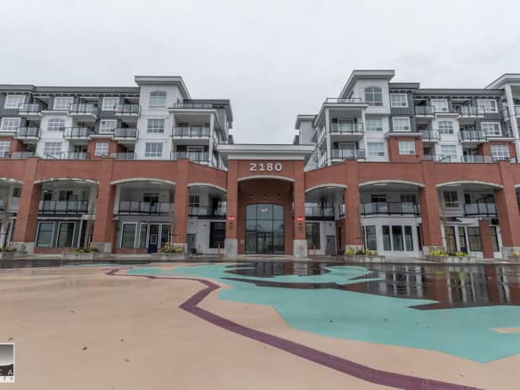 Modern waterfront condominium building with mixed-use commercial spaces, situated in a prime location featured by Orca Realty Inc. in Vancouver, BC.