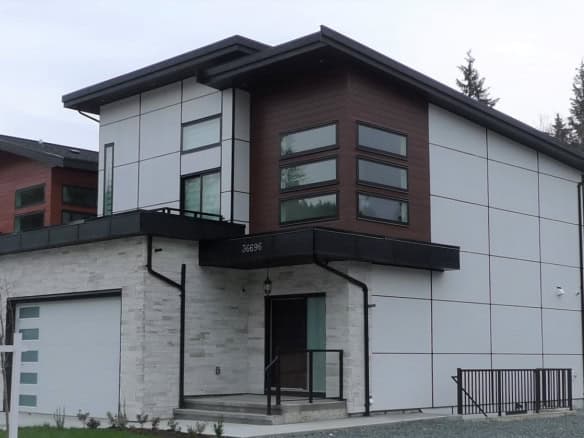 Modern contemporary home with sleek design and large windows, located in a residential neighbourhood in Vancouver, BC. Expertly crafted by Orca Realty Inc. offering premium real estate services in BC.