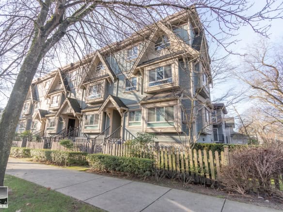 Spacious multi-family townhouse with modern architecture, surrounded by trees and greenery, ideal for Vancouver real estate investment or family living in British Columbia.