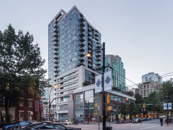 Modern high-rise condominium building in downtown Vancouver, BC, showcasing luxury amenities and prime residential and commercial spaces.
