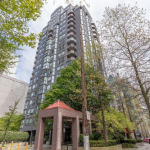 Modern high-rise residential building in downtown Vancouver with lush greenery and outdoor amenities.