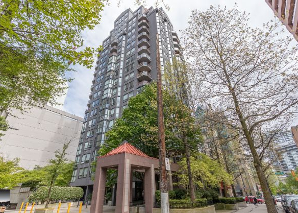 Modern high-rise residential building in downtown Vancouver with lush greenery and outdoor amenities.