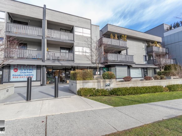 Modern multi-family residential building with commercial spaces on the ground floor, featuring balconies, landscaped greenery, and contemporary architecture in Vancouver, BC.