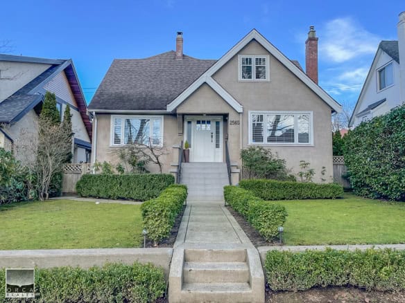 Charming 2-storey family home with well-maintained front yard, manicured shrubs, and classic architectural style, located in a desirable neighbourhood with easy access to amenities and parks.