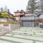 Contemporary multi-level house with large glass balconies, modern design, and landscaped front yard in Vancouver, BC. Perfect for luxury real estate buyers seeking stylish and spacious homes.
