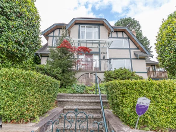 Bright multi-story house with lush green landscaping and a front staircase leading to the entrance, showcasing modern architecture and a welcoming exterior for Vancouver Bay area homes.