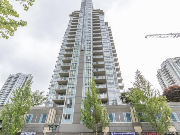 Modern high-rise condominium building with spacious balconies in downtown Vancouver, BC. Perfect for luxury real estate buyers seeking urban living at Orca Realty Inc.