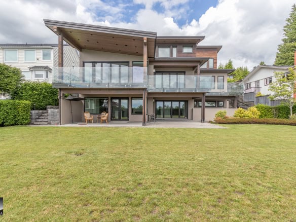 Spacious modern house with large backyard, outdoor patio, and elevated balconies in a quiet neighbourhood, ideal for family living and entertaining, showcasing luxury residential real estate in Canada.