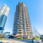 Modern high-rise condominium building in Vancouver with contemporary architecture and spacious balconies, offering luxury living and stunning city views.